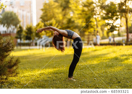 Plastic girl doing yoga in the park. Summer evening. Plastic girl doing yoga in the park. Summer evening. 68593321