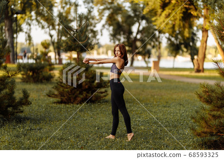 Plastic girl doing yoga in the park. Summer evening. Plastic girl doing yoga in the park. Summer evening. 68593325