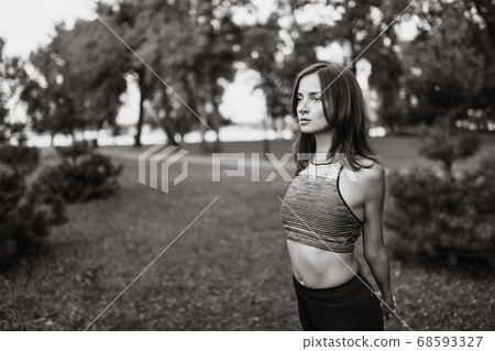 Black-white portrait of a girl in the park. Yoga and fitness 68593327