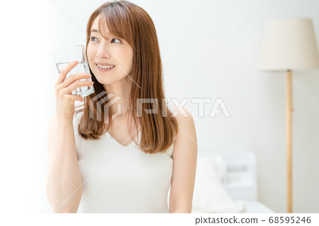 Young woman hydrating at home 68595246