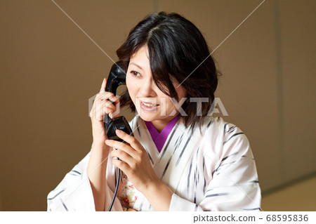 Woman in black dress with black phone 68595836