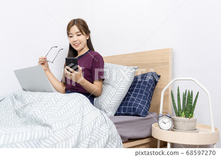Asian woman working with smartphone or tablet on Asian woman working with smartphone or tablet on 68597270