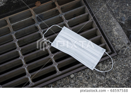 Abandoned mask beside the pavement Abandoned mask beside the pavement 68597588
