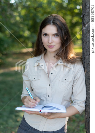 Young beautiful girl student in shirt by day 68598702
