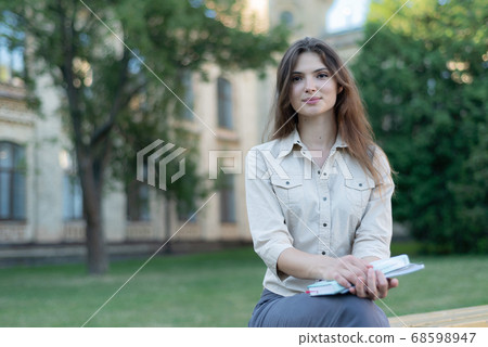 Young beautiful girl student in shirt by day 68598947