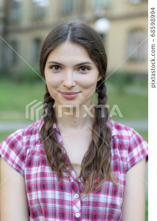 Young girl in a red plaid shirt 68598994