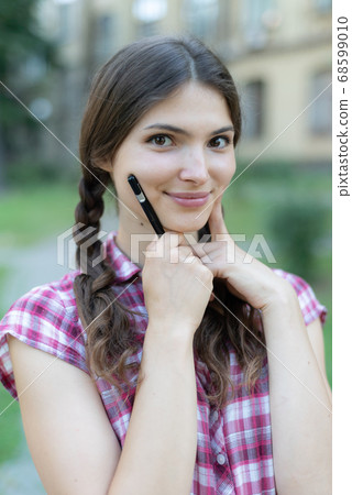 School and education: Young girl student with pen 68599010