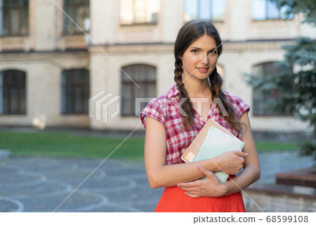 Girl student in red skirt and plaid shirt 68599108