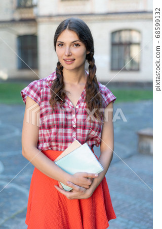 Girl student in red skirt and plaid shirt 68599132