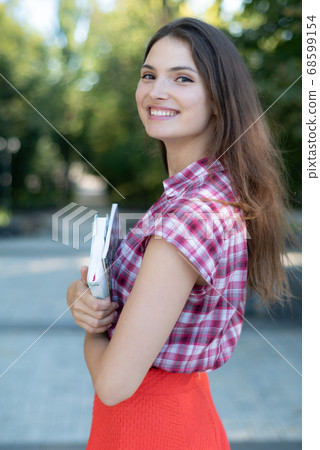Girl student in red skirt and plaid shirt Girl student in red skirt and plaid shirt 68599154