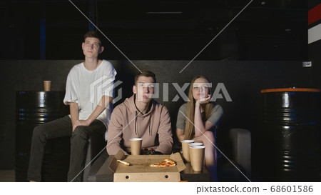 Best friends eating popcorn and chips watching movie or tv show at home. People, friendship and lifestyle concept 68601586