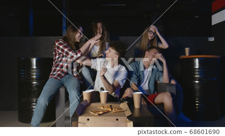 Having fun with friends. Happy man completes hard level in video game 68601690