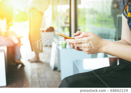 hand holding smartphone searching information on blurred background 68602229