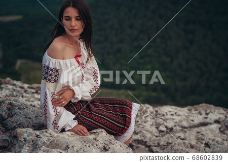 Atractive woman in traditional romanian costume on Atractive woman in traditional romanian costume on 68602839