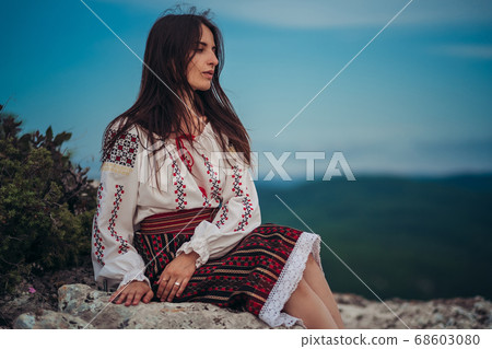 Atractive woman in traditional romanian costume on Atractive woman in traditional romanian costume on 68603080