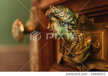 beautiful female head shaped door handle on a wooden door beautiful female head shaped door handle on a wooden door 68606825