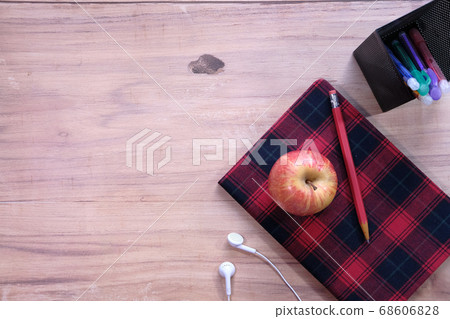 Top view of apple and notepad on white background. Top view of apple and notepad on white background. 68606828