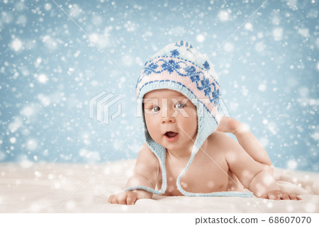 Eight month old baby lying on soft blanket Eight month old baby lying on soft blanket 68607070