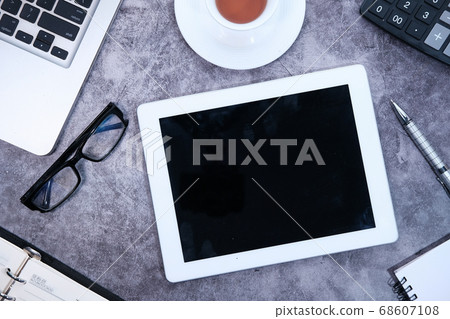 Top view of digital tablet, laptop and notepad on table  68607108