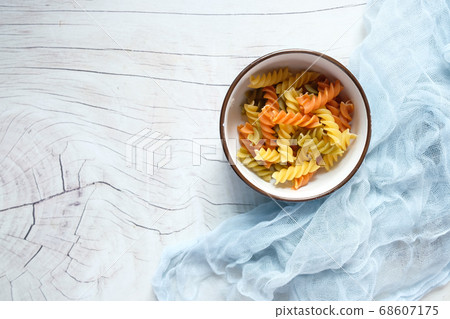 Variety of types and shapes of dry Italian pasta in a bowl. 68607175