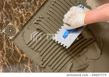 Close-up of a master's hand that makes furrows in 68607574