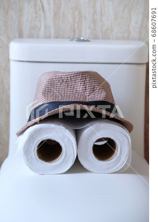 roll of toilet paper and hat, close up roll of toilet paper and hat, close up 68607691
