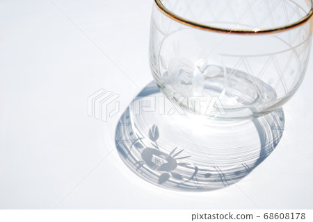 Glass cup and shadow Glass cup and shadow 68608178