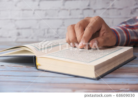 Close up of man hand reading holly quran. 68609030