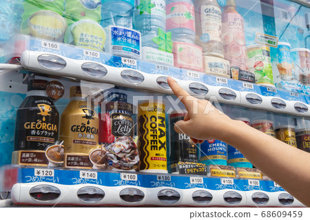Female hands buying juice at vending machine Female hands buying juice at vending machine 68609459