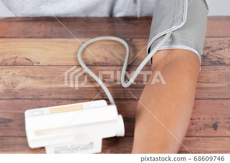 Man's arm doing blood pressure measurement Man's arm doing blood pressure measurement 68609746