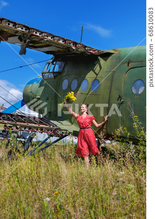 Young woman in a red pin up dress waving a bunch Young woman in a red pin up dress waving a bunch 68610083