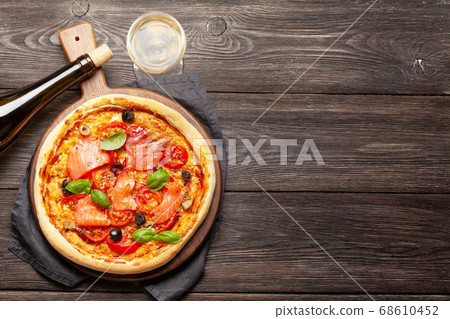 Tasty homemade seafood pizza with salmon Tasty homemade seafood pizza with salmon 68610452