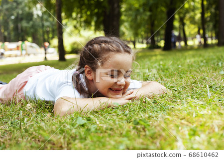 little cute caucasian girl playing cheerful in green park at summer, lifestyle people concept 68610462