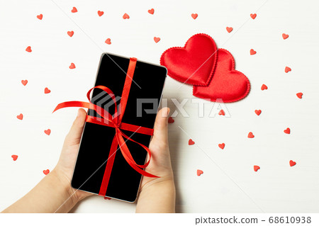 child holding a phone child holding a phone 68610938