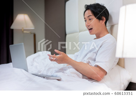 A young man in a futon talking to her in a zoom A young man in a futon talking to her in a zoom 68613351
