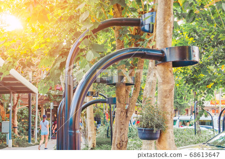 Black steel column supports and controls the branches and trunks of the tree to stand upright and beautiful in the park. Black steel column supports and controls the branches and trunks of the tree to stand upright and beautiful in the park. 68613647