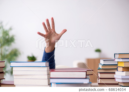 Young male student preparing for exams at home Young male student preparing for exams at home 68614034