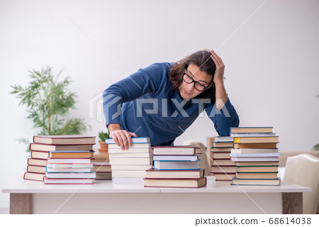 Young male student preparing for exams at home Young male student preparing for exams at home 68614038