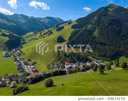 Aerial view of Hinterglemm village and mountains in Saalbach-Hinterglemm skiing region in Austria on a beautiful summer day Aerial view of Hinterglemm village and mountains in Saalbach-Hinterglemm skiing region in Austria on a beautiful summer day 68614210