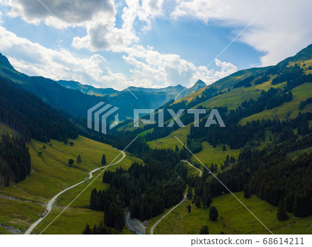 Aerial view into the valley head of the Hinterglemm Mountains on a summer day in the Alps at Saalbach-Hinterglemm, Austria Aerial view into the valley head of the Hinterglemm Mountains on a summer day in the Alps at Saalbach-Hinterglemm, Austria 68614211