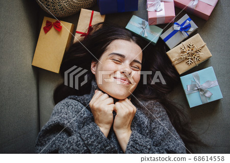 Cute young woman with many packed presents Cute young woman with many packed presents 68614558