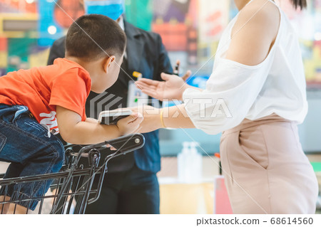 All customers must check the temperature and wash their hands with alcohol gel before shopping to prevent Coronavirus (Covid-19) at the entrance to Department Store. New normal lifestyle. 68614560