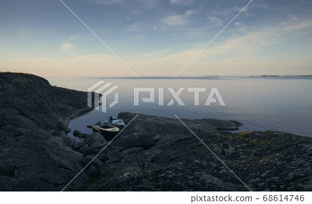 Old motor boats parked near rocky shore Old motor boats parked near rocky shore 68614746