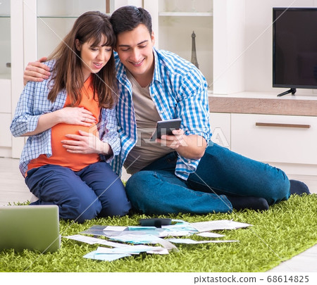 Young family in budget planning concept 68614825