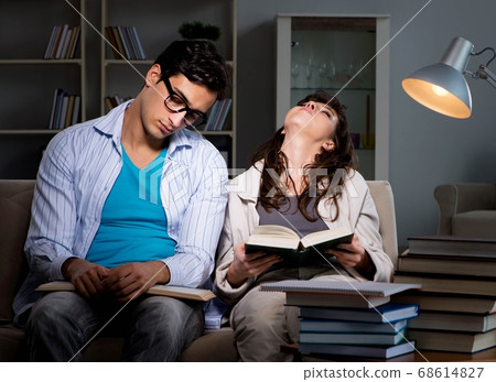Two students studying late preparing for exams Two students studying late preparing for exams 68614827