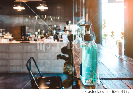 Blue alcohol gel bottle for hand cleaning to prevent the spreading of the Corona virus (Covid-19), Place the entrance service for customers  in the cafe. Healthcare concept. 68614952