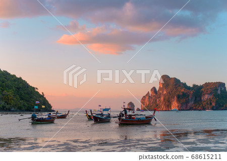 Charming sunset over a tropical island. Low tide, fishing boats. Charming sunset over a tropical island. Low tide, fishing boats. 68615211