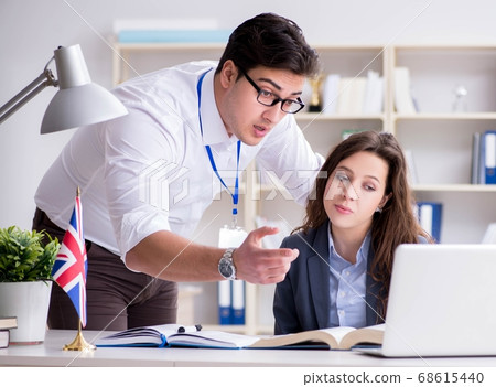 Teacher explaining to student at language training Teacher explaining to student at language training 68615440