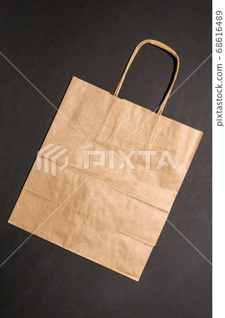 Eco concept. Cardboard boxes, paper bag on black background. Top view. Eco shopping concept, zero waste. Eco concept. Cardboard boxes, paper bag on black background. Top view. Eco shopping concept, zero waste. 68616489