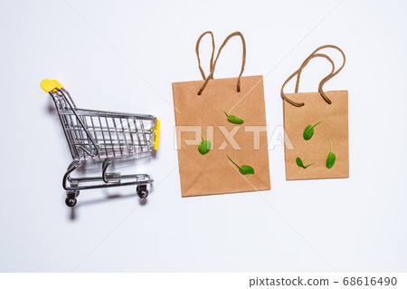 brown paper bag with shopping handles space for copying text. Shopping cart on a white background brown paper bag with shopping handles space for copying text. Shopping cart on a white background 68616490